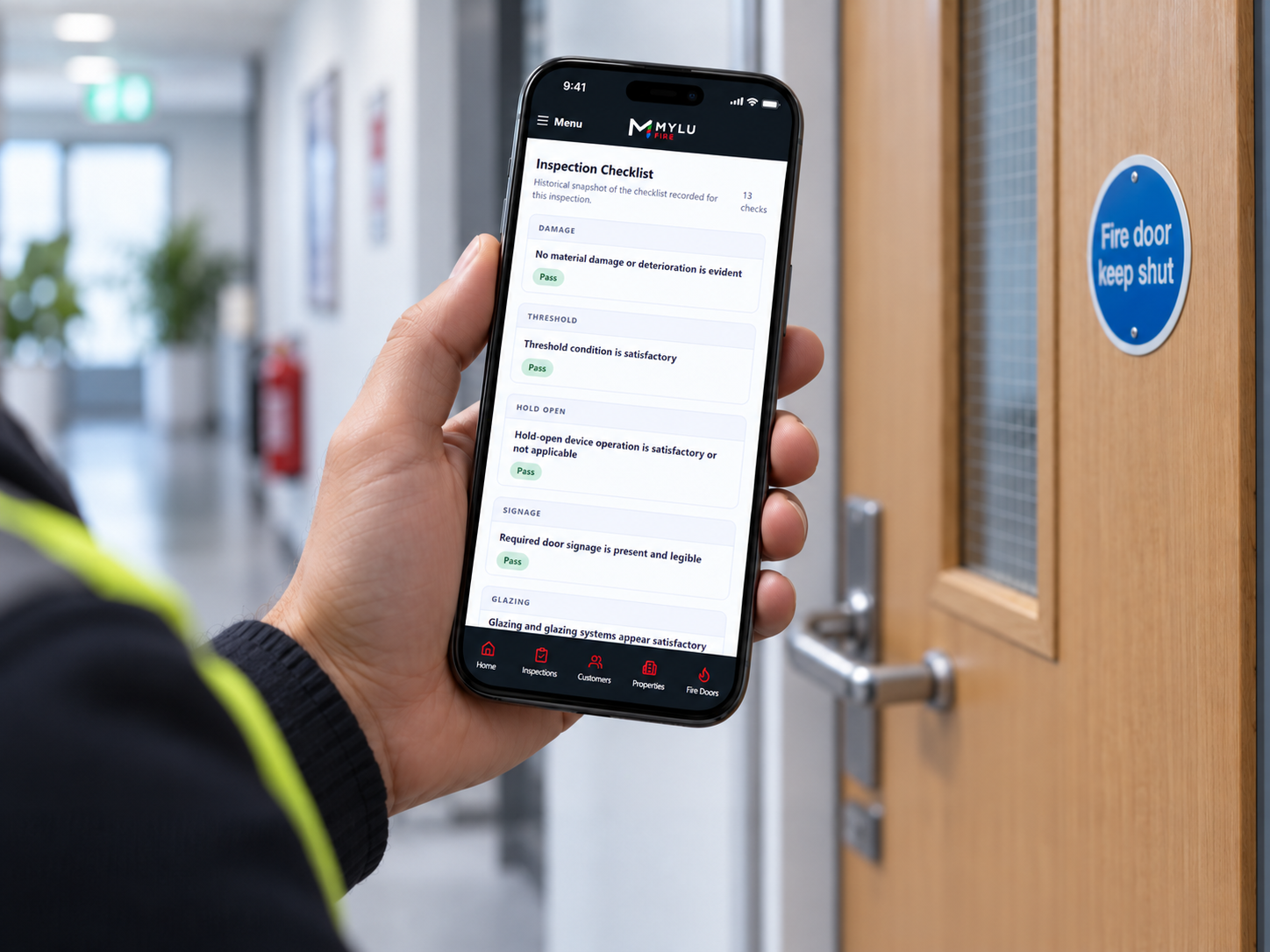 Inspector using MYLU Fire during a fire door inspection