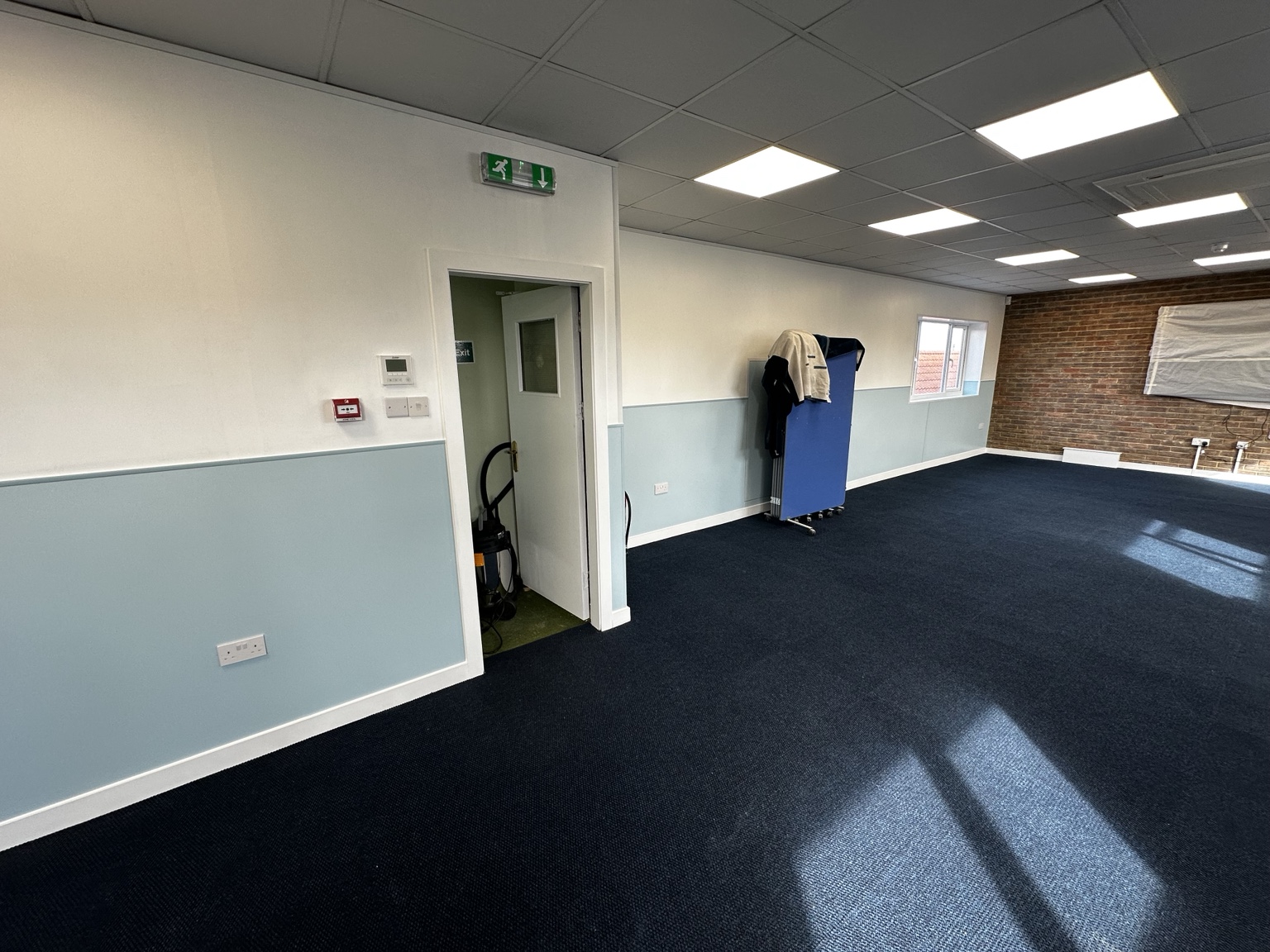 Completed commercial room with new flooring, walls and fitted elements